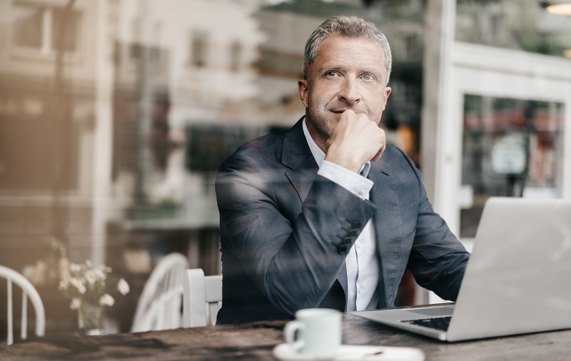 Businessman sitting in cafe, working