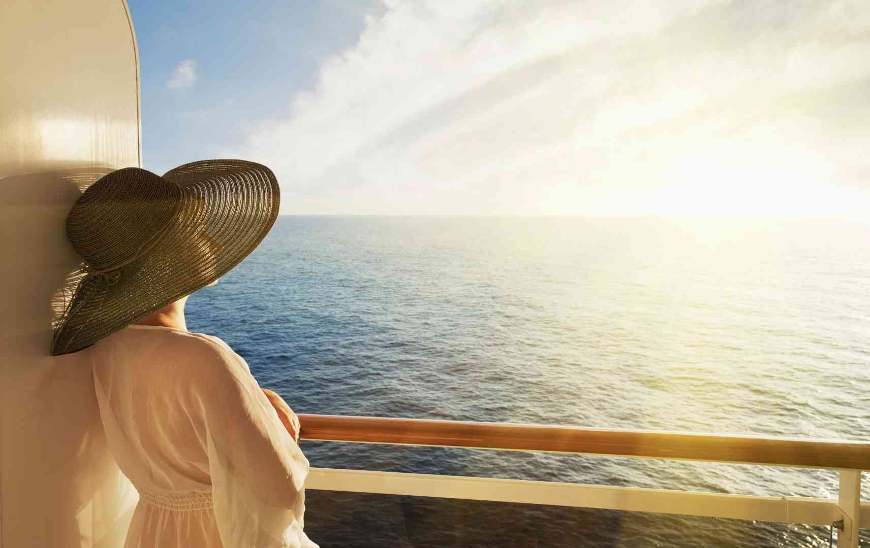 Frau auf Kreuzfahrt blickt aufs Meer